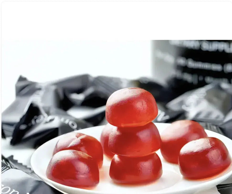 Allebuy shilajit gummies red supplement gummies stacked on white plate with packaging in background