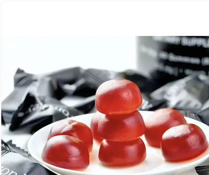 Allebuy shilajit gummies red supplement gummies stacked on white plate with packaging in background