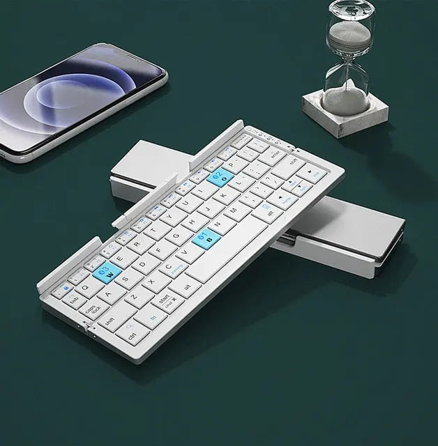Allebuy sleek white keyboard with bluetooth and foldable design placed next to smartphone and hourglass