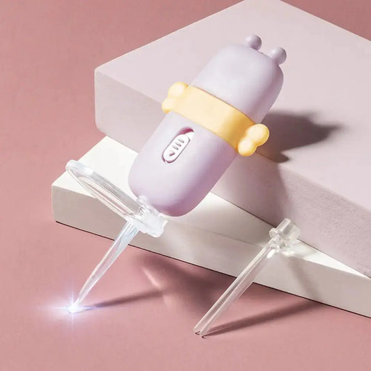 Purple ear candle wax remover with yellow grip and clear disposable tips on pink and white background