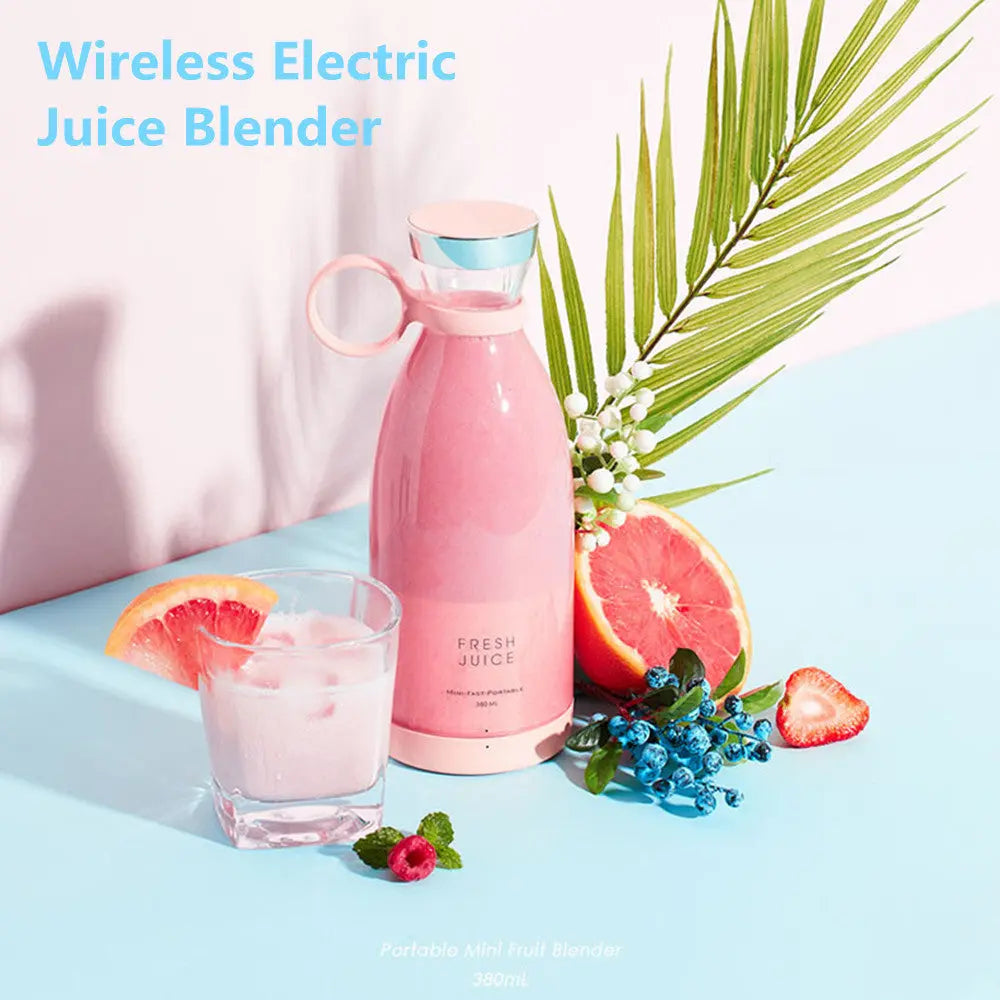 Pink ninja blast portable blender with fresh juice, glass of juice, and assorted fruits on blue surface