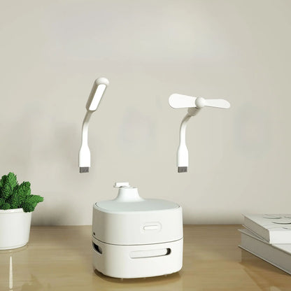 Allebuy compact robot robot vacuum cleaner in white with USB light and fan attachments on a wooden surface
